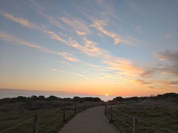 Scenic view of field against sky during sunset