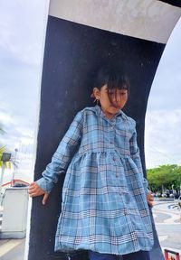 Full length of woman standing against sky