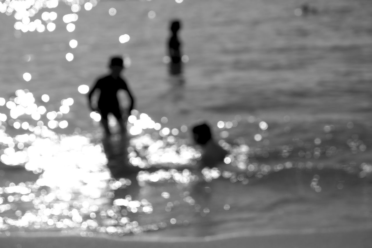 water, lifestyles, leisure activity, silhouette, sea, walking, wet, childhood, reflection, men, boys, full length, waterfront, standing, person, rear view, nature