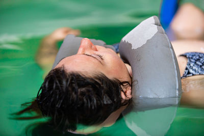 Woman lying on swimming pool