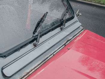 High angle view of wet car on road by wall
