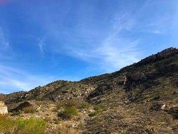 Low angle view of mountain against blue sky