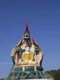 Low angle view of statue against blue sky