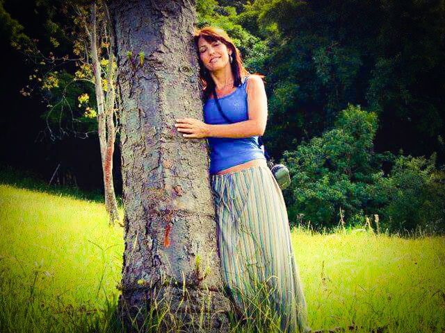 plant, tree, casual clothing, real people, leisure activity, young adult, tree trunk, trunk, one person, land, lifestyles, growth, standing, grass, nature, field, day, green color, young women, outdoors, hairstyle, contemplation