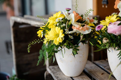 Close-up of yellow flower pot on table