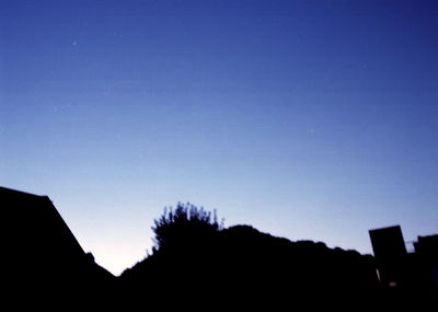 Low angle view of built structure against clear blue sky