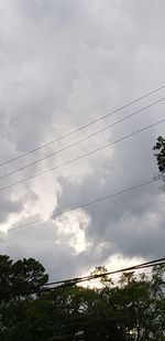 Low angle view of power lines against sky