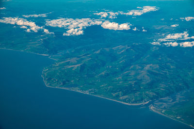 Aerial view of sea seen through airplane window