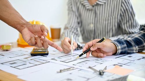 Midsection of man working on table