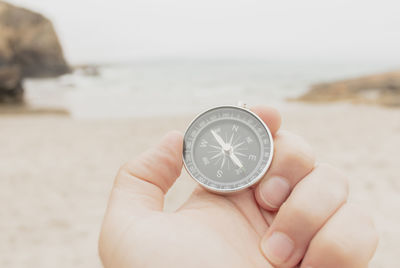 Cropped hand holding navigational compass