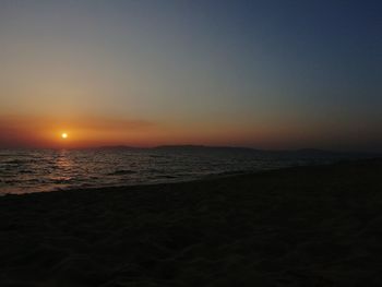 Scenic view of sea against clear sky during sunset