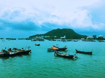 Boats in sea against sky
