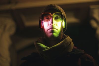 Close-up of man wearing illuminated headphones
