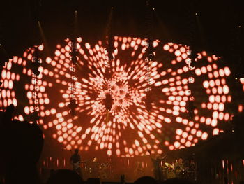 Illuminated fireworks against sky at night