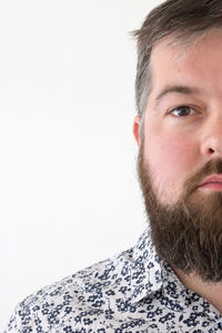 Close-up portrait of man against white background