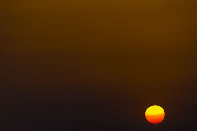 Close-up of yellow moon at sunset