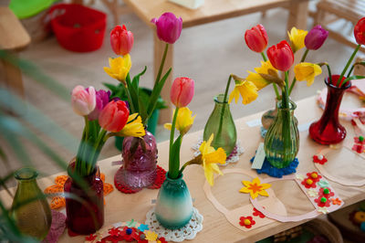 Close-up of multi colored flowers in vase on table