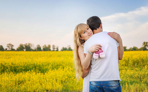 Couple embracing in field