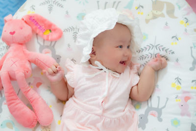 High angle view of cute baby girl sleeping on bed at home