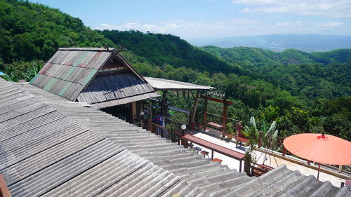 High angle view of building by trees against sky