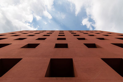 Low angle view of building against cloudy sky