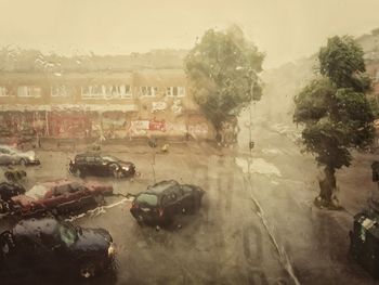 Cars on road in city against sky