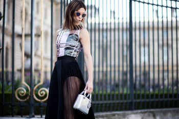PORTRAIT OF A YOUNG WOMAN STANDING ON WALL