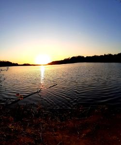 Scenic view of lake against sky during sunset