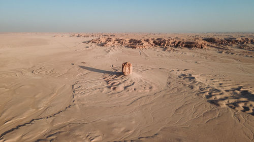 Scenic view of sand dune in desert against sky