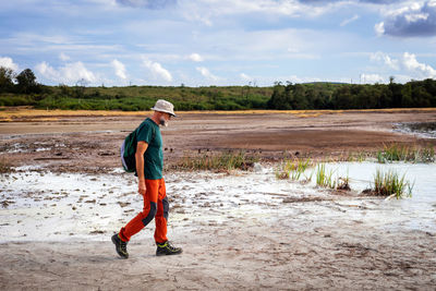 Hiker visits the caldera, a small circular crater with a marsh of sulphurous waters