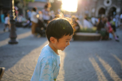 Side view of boy standing on street
