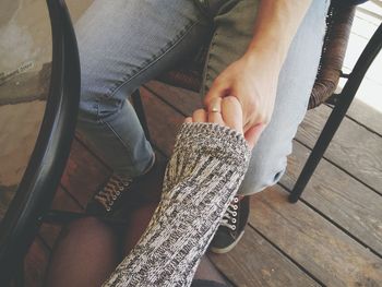 High angle view of couple holding hands while sitting at table