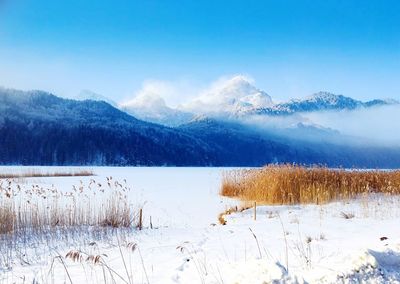 Scenic view of lake and mountains against sky