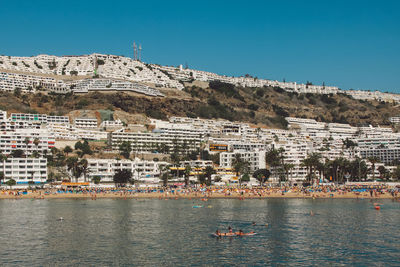 Scenic view of city against clear blue sky
