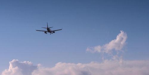 Low angle view of airplane flying in sky