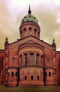 Low angle view of building against cloudy sky