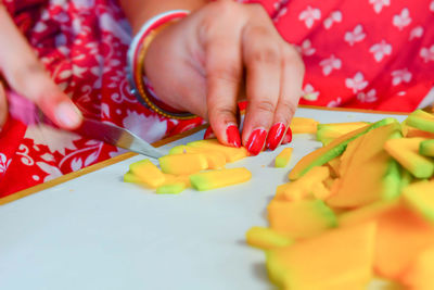 Midsection of woman holding red chili peppers