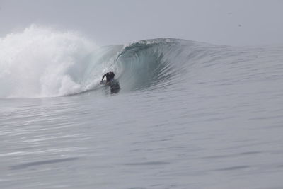 Man surfing on sea