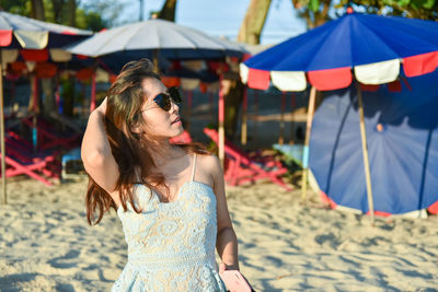 Woman with umbrella on beach