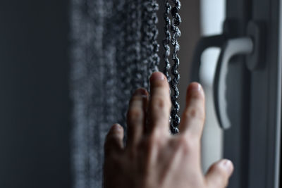 Close-up of hand reaching towards decoration in darkroom