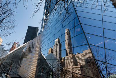 Low angle view of modern buildings against clear blue sky