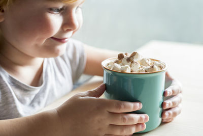 Close-up of girl holding hot chocolate
