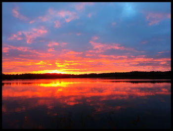 Reflection of clouds in lake at sunset