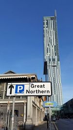 Low angle view of building against clear blue sky