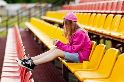 Young woman sitting on chairs