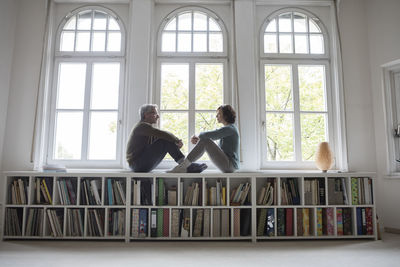 Mature couple sitting at the window