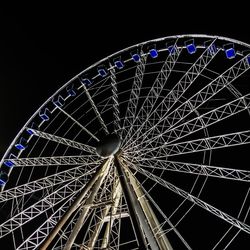 Low angle view of ferris wheel against sky at night
