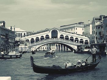 Boats in river with city in background