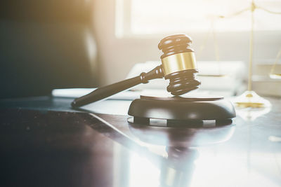 Close-up of gavel on table