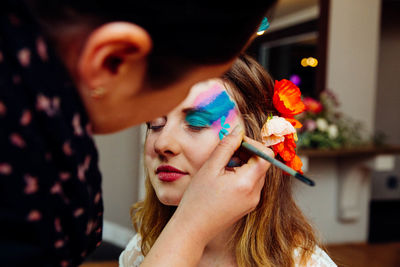 Artist painting on woman face